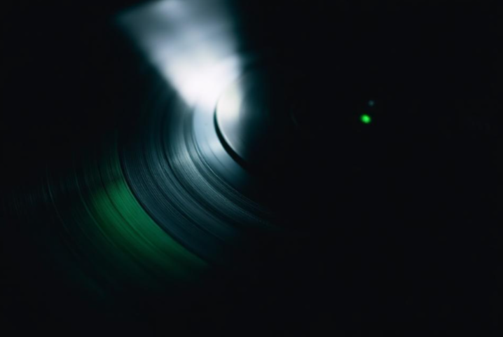 Macro photograph of a record groove under green light