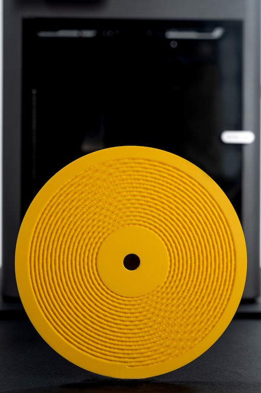 A 3D printer producing a playable vinyl-style record disc